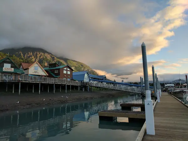 Seward Alaska harbor at dawn with dramatic clouds and mountain backdrop
