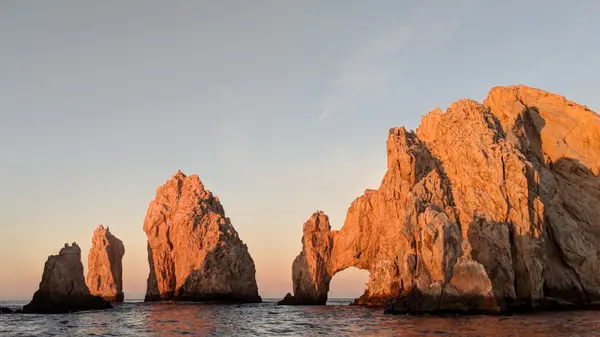 El Arco rock arch at Cabo San Lucas glowing golden at sunset